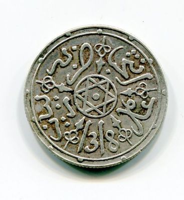 an image of a silver coin on a white surface