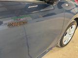 a close up of a car door with a sticker on it