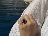 a woman that is holding a ring in her hand