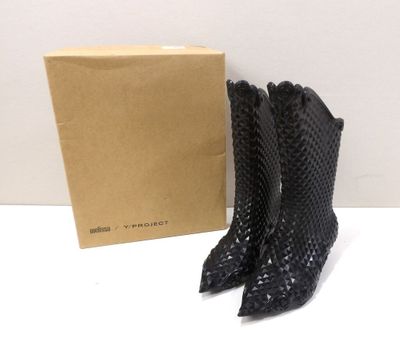 a pair of black leather boots with a box on the side