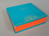 an orange and blue box with a tree on top of it