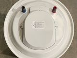 an overhead view of a white toilet with a red and blue lid