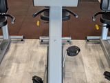 an image of a row of stationary exercise bikes in a gym