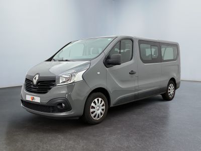 the grey van is parked in a large room with a black floor