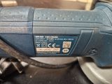 an image of a close up of a corded sander on a table