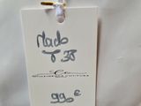 a white bag with a tag attached to it