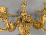 a gold colored chandelier with three lights on it
