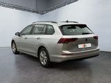 the rear end of a silver volkswagen passat parked in a garage