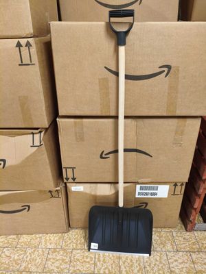 boxes stacked on top of each other with a black shovel on top of them