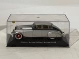 a model of a silver car in a clear box