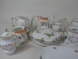 a table with a lot of different types of china on it