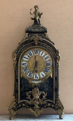 a black and gold clock sitting on a table