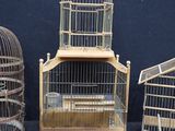three bird cages sitting next to each other on a table