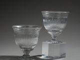 two glass vases that are sitting on a table