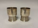 pair of silver plated cups on a white background