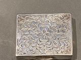 a small silver box sitting on a table