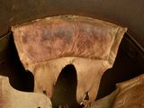 a brown leather hat with a brown leather hat on it