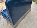 a blue couch that is sitting on top of a platform