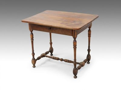 an old wooden table with turned legs and a wooden top