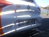 a white car with orange stripes parked on the side of the road