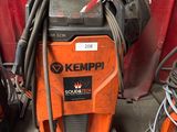 a machine that is sitting in the garage with other equipment