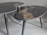 two tables that are sitting side by side on the floor