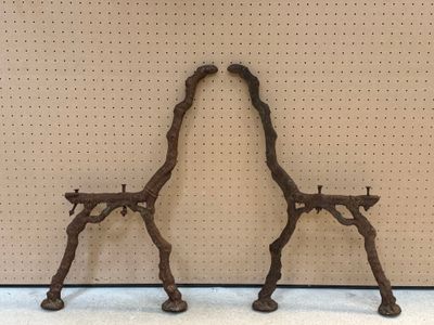 two metal giraffes that are standing next to each other
