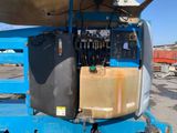 an image of a blue lift truck with a boat on it ' s back