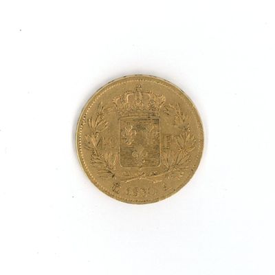 an old coin on a white surface with a white background