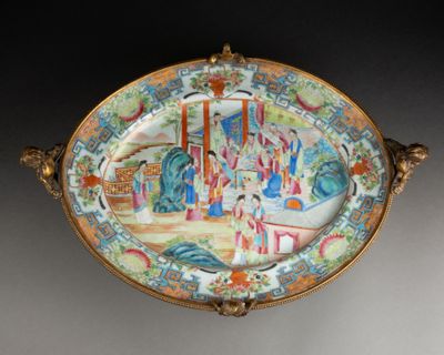 a decorative plate with a painting on it on a table