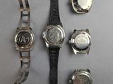 a lot of watches that are laying out on the table
