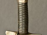 a close up of a sword with a metal handle
