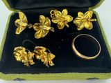 a box with a bunch of gold jewelry inside of it