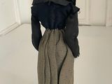 doll made of cloth and cloth cloth with a black hat on top of it
