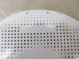 a close up of a white object with holes on it