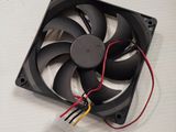a close up of a fan on a table with wires