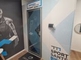 a wall mural of a man holding a tennis racquet in a gym
