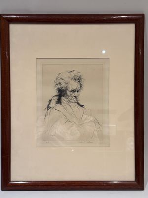 framed drawing of a man in a turban sitting in front of a white wall