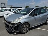 une voiture argentée garée sur un parking, avec d'autres voitures en arrière-plan