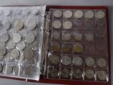 a binder with a lot of coins inside of it