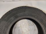 a tire that is sitting on a white sheet