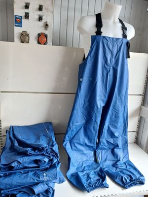 a mannequin and a pair of blue pants on a white table