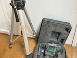 a tripod and a camera in a case on the floor