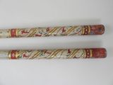 these are two baseball bats with designs on them on a white surface