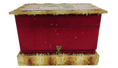 a small red box with a picture on top of it