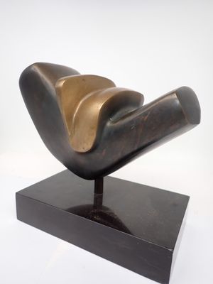 bronze sculpture of a bird on a black base on a white background