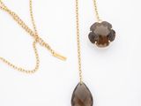 a pair of smoky quartz tear shaped pendants on a gold chain