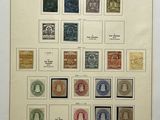 an old picture of a collection of stamps on display in a glass case