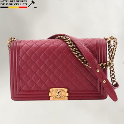 a chanel red quilted leather shoulder bag with gold hardware