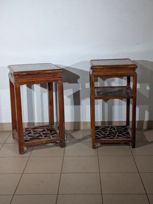 two side tables that are sitting on a tiled floor